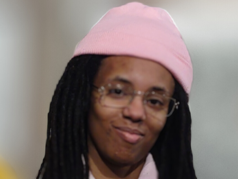 Taiyah in a pink hat and sly smile welcomes you in.