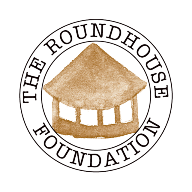 Serif allcaps words "The Roundhouse Foundation" circle neatly around a depiction of a brown round structure with a pointed roof.