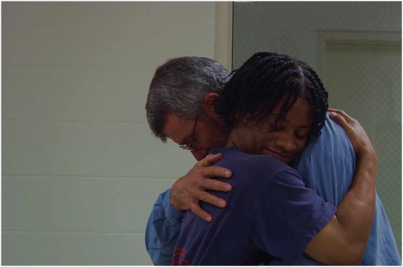 Two actors hug during a rehearsal of A Midsummer Night's Dream.