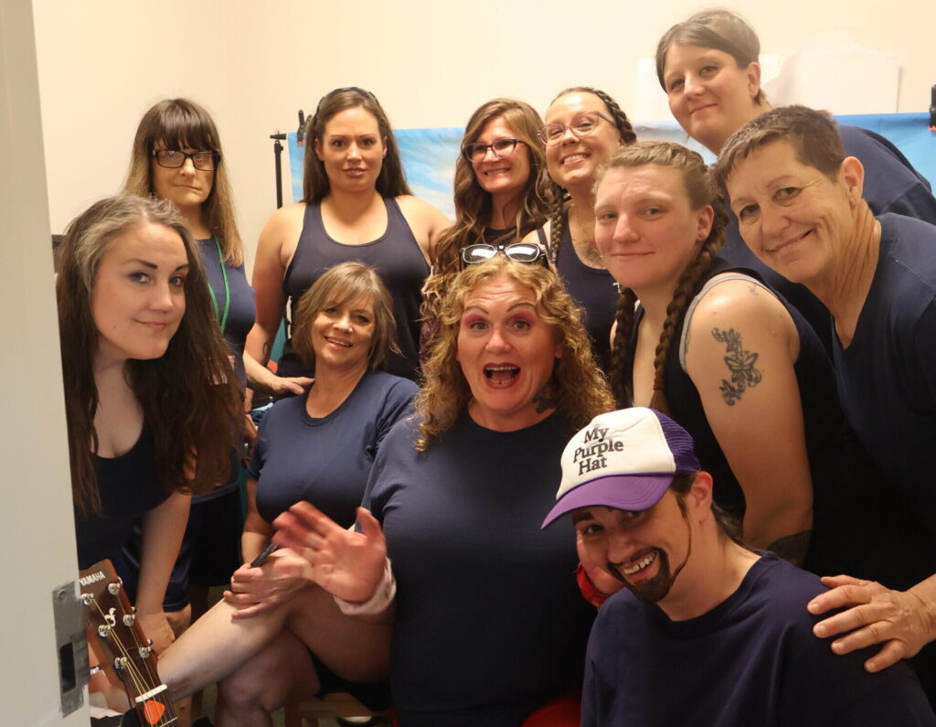 The 11-woman cast of The Sisterhood of the Traveling Cuffs.