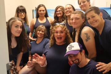 The 11-woman cast of The Sisterhood of the Traveling Cuffs.