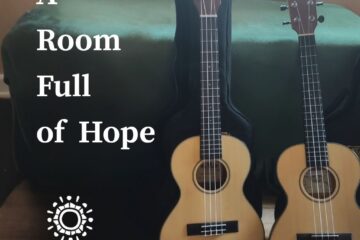 Two ukuleles leaning up against a chest.